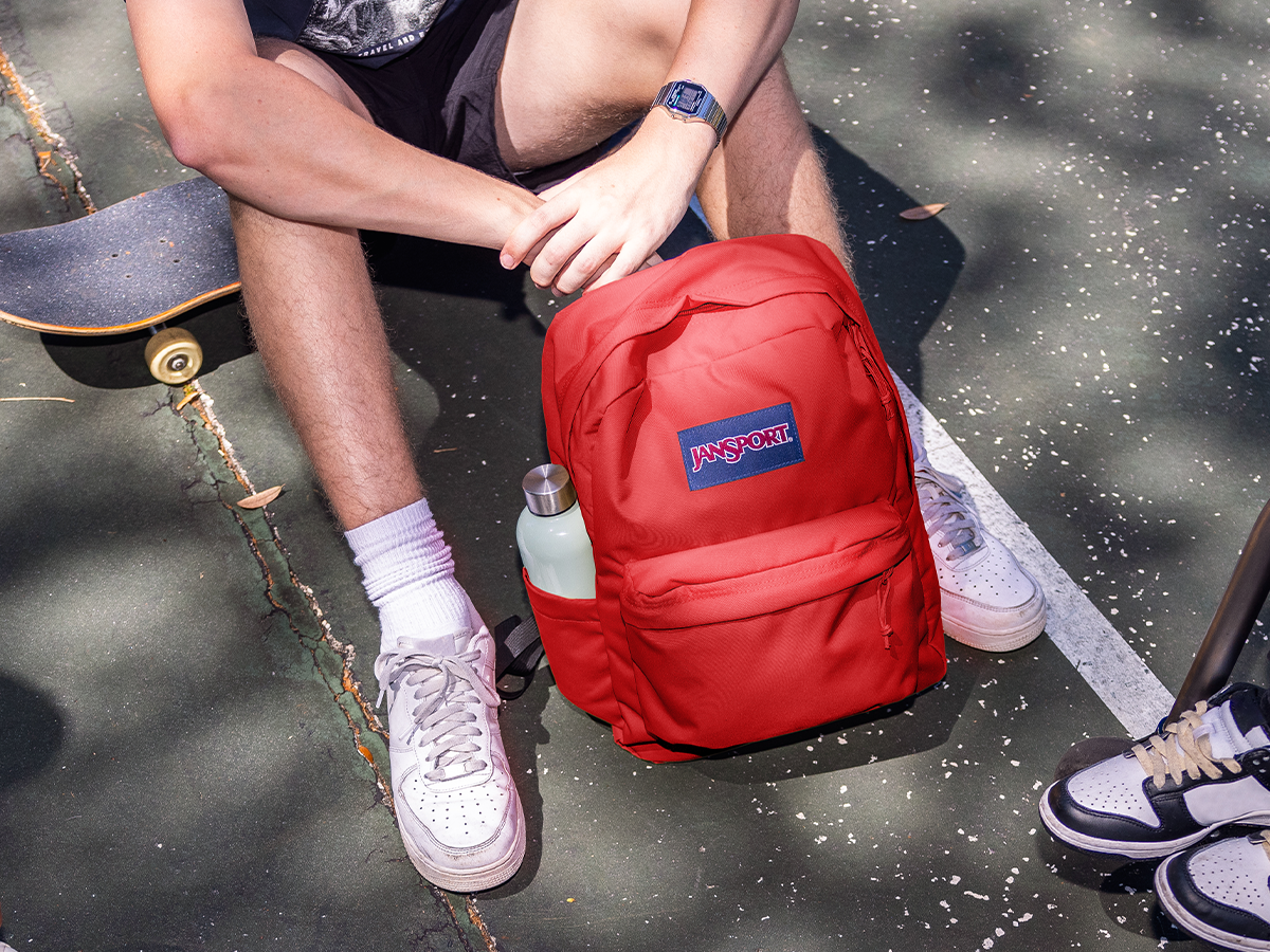 jansport backpack on person Right Pack - Durable Daypack with Padded 15" Laptop Sleeve, Spacious Main Compartment & Integrated Water Bottle Pocket and hoodies in check Backpacks for School, Work, &